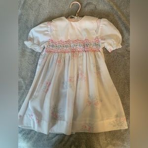 Beautiful lightweight baby girls Polly Flinders dress with hand smocking.